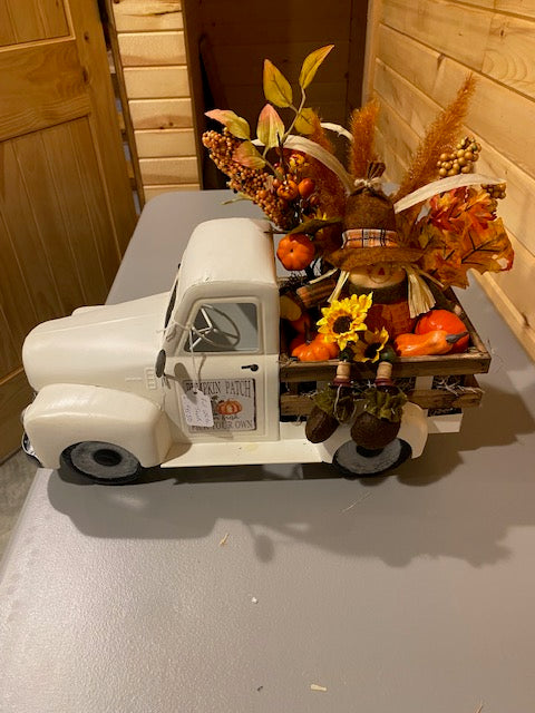 Scarecrow in White Pickup Truck with Fall Decor